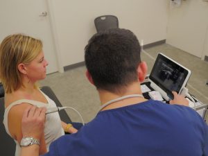 Reviewing Diagnostic Shoulder Ultrasound with Osteopath Patient